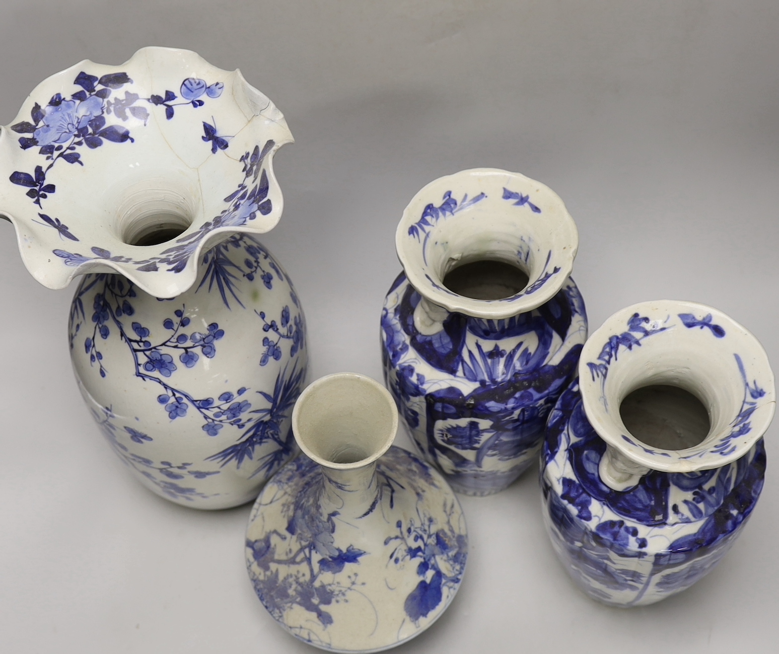 A pair of Japanese blue and white birds and flowers pattern vases and two other vases, tallest 39cm high